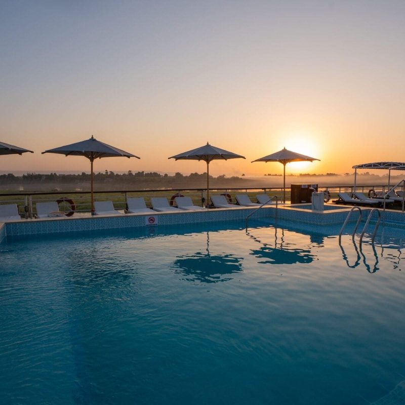 Pool deck aboard the M/S City & Sea Adonis at sunrise over the Nile River