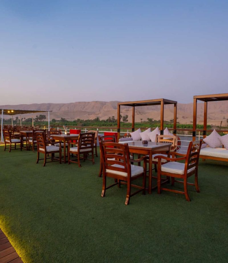 Sun deck lounge and dining area aboard the M/S City & Sea Adonis with Nile Valley views.