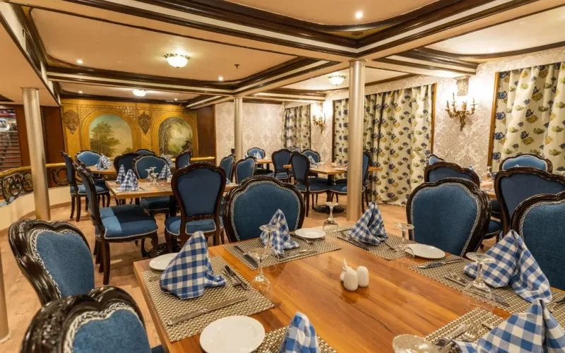 Elegant dining room with blue chairs and formal table settings