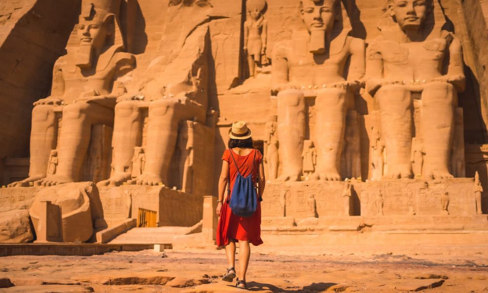 young-tourist-red-dress-walking-towards-abu-simbel (1)